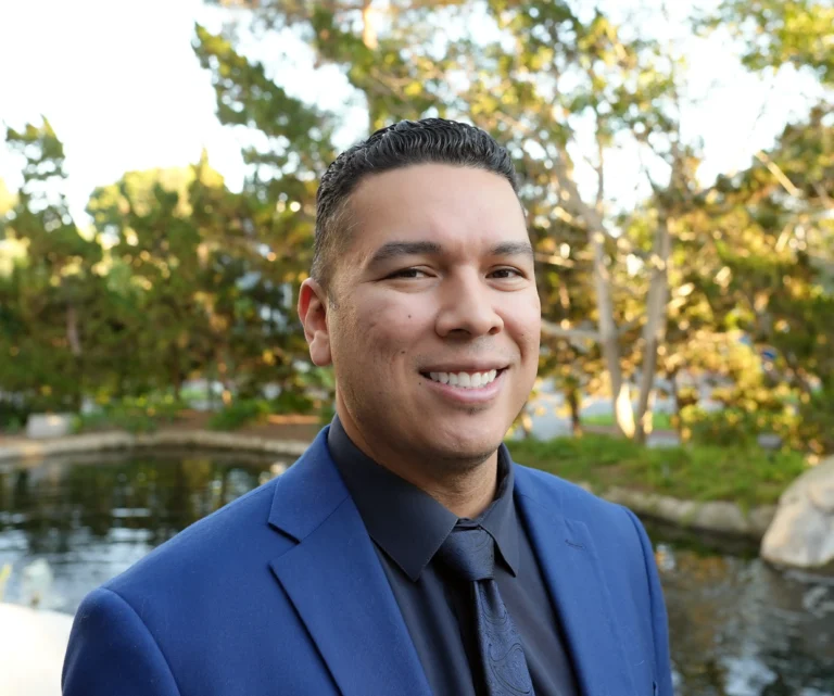 man standing in front of pond